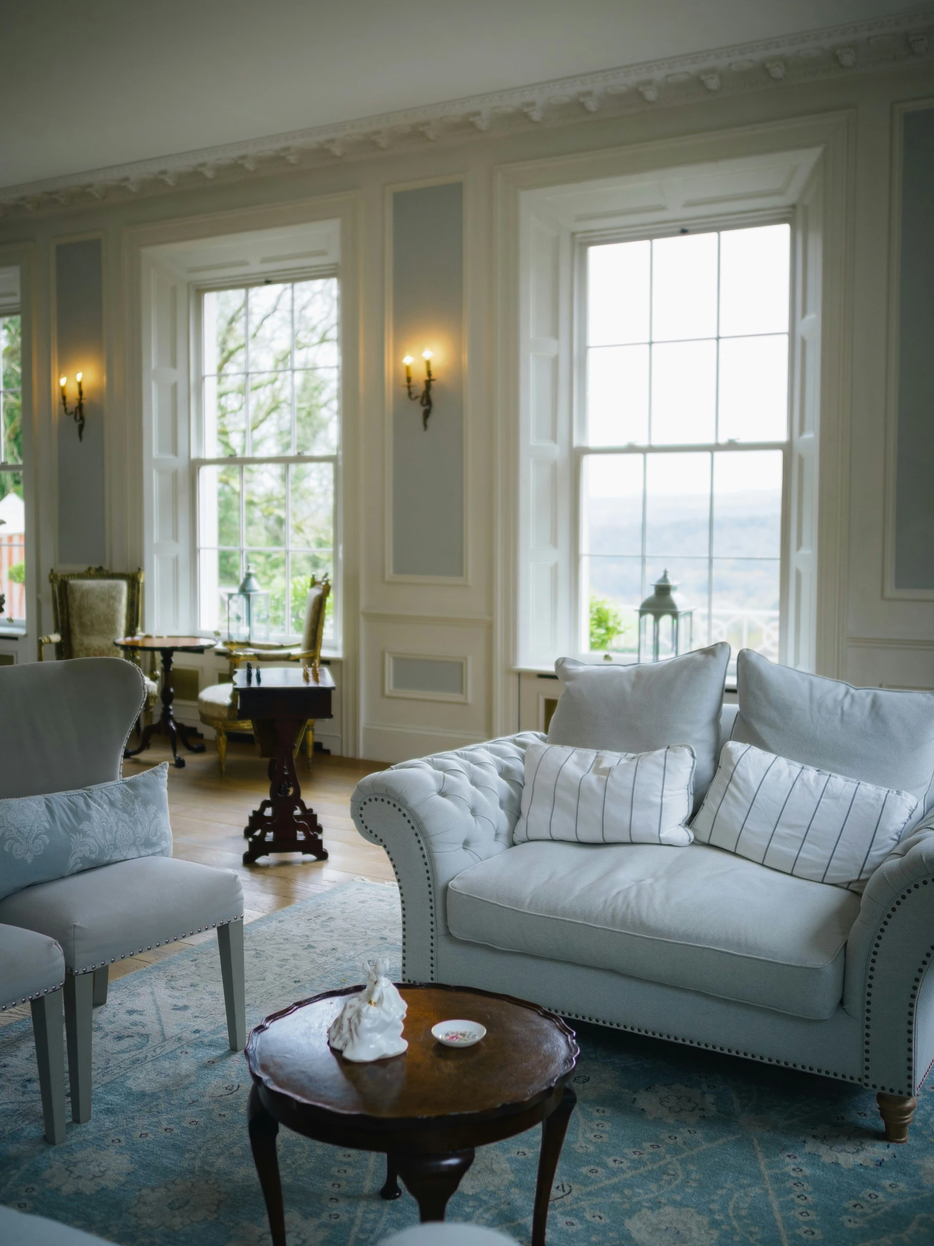 Elegant living room with plush sofa and large windows