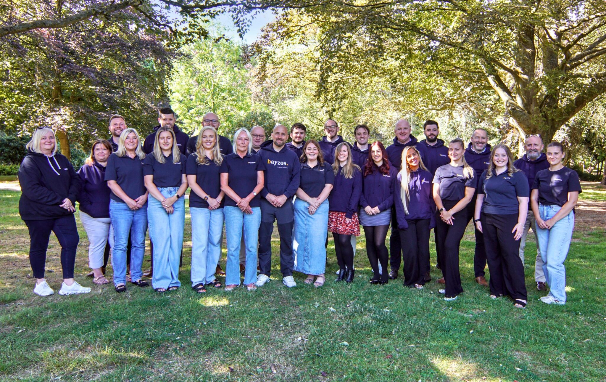 The team from Bayzos estate agents stand together in Coventry War Memorial Park