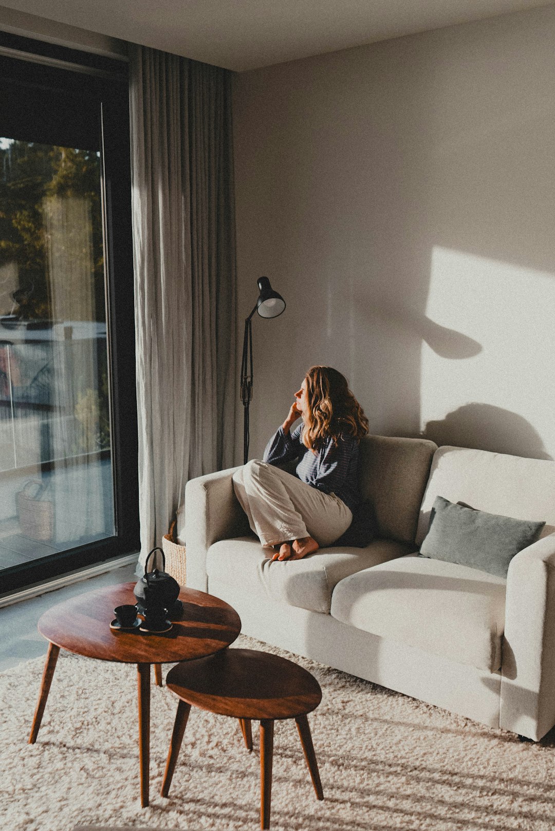 Person reading in a cosy home interior