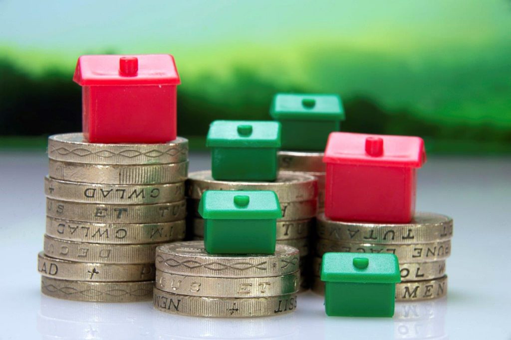 Property investment concept with houses and coins