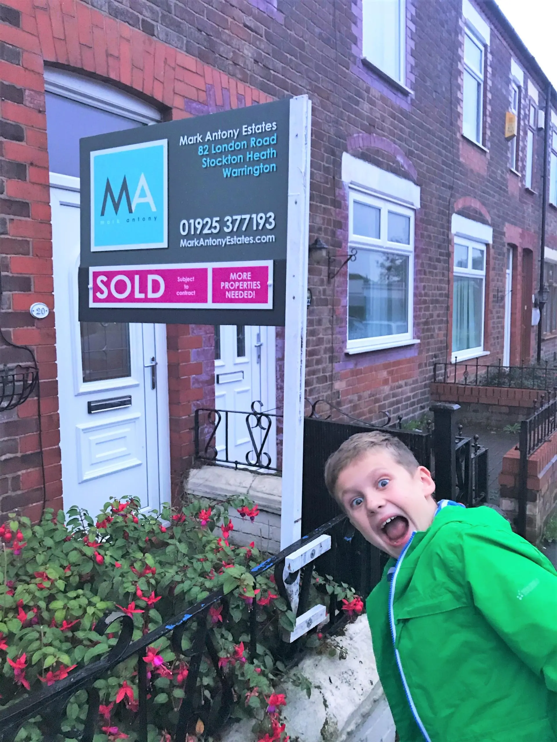 Child in green jacket posing in front of a brick building with a Mark Antony Estates "SOLD" sign, 82 London Road, Stockton Heath, Warrington