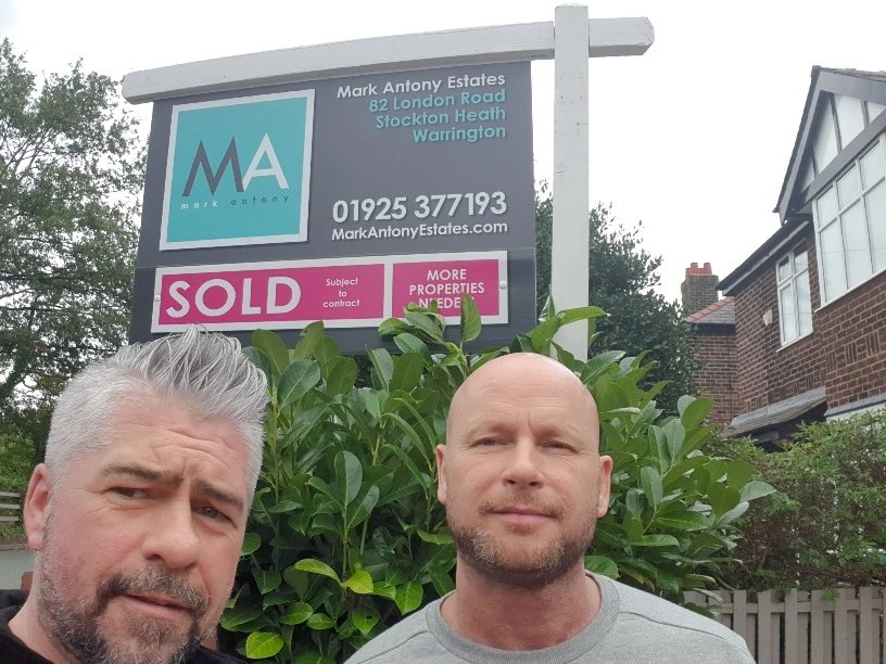 Two men standing in front of a Mark Antony Estates property board showing "SOLD Subject to contract" at 82 London Road, Stockton Heath, Warrington
