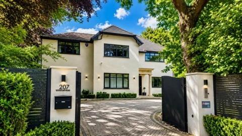 Cream detached house with gated driveway
