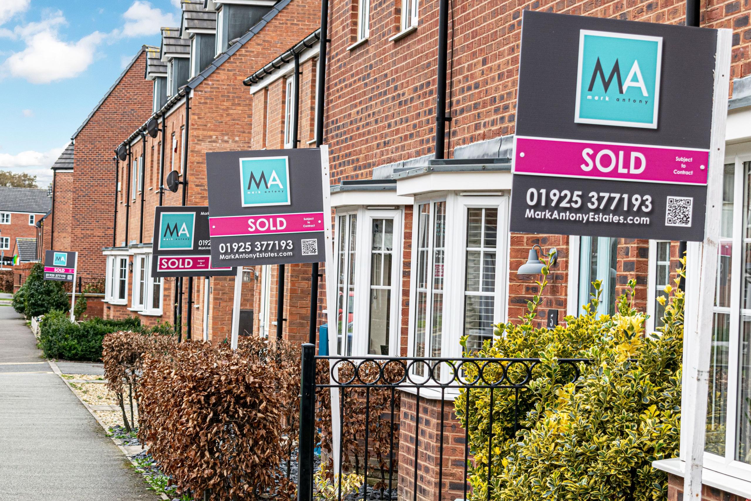 A street with multiple Sold boards sold by mark antony estates