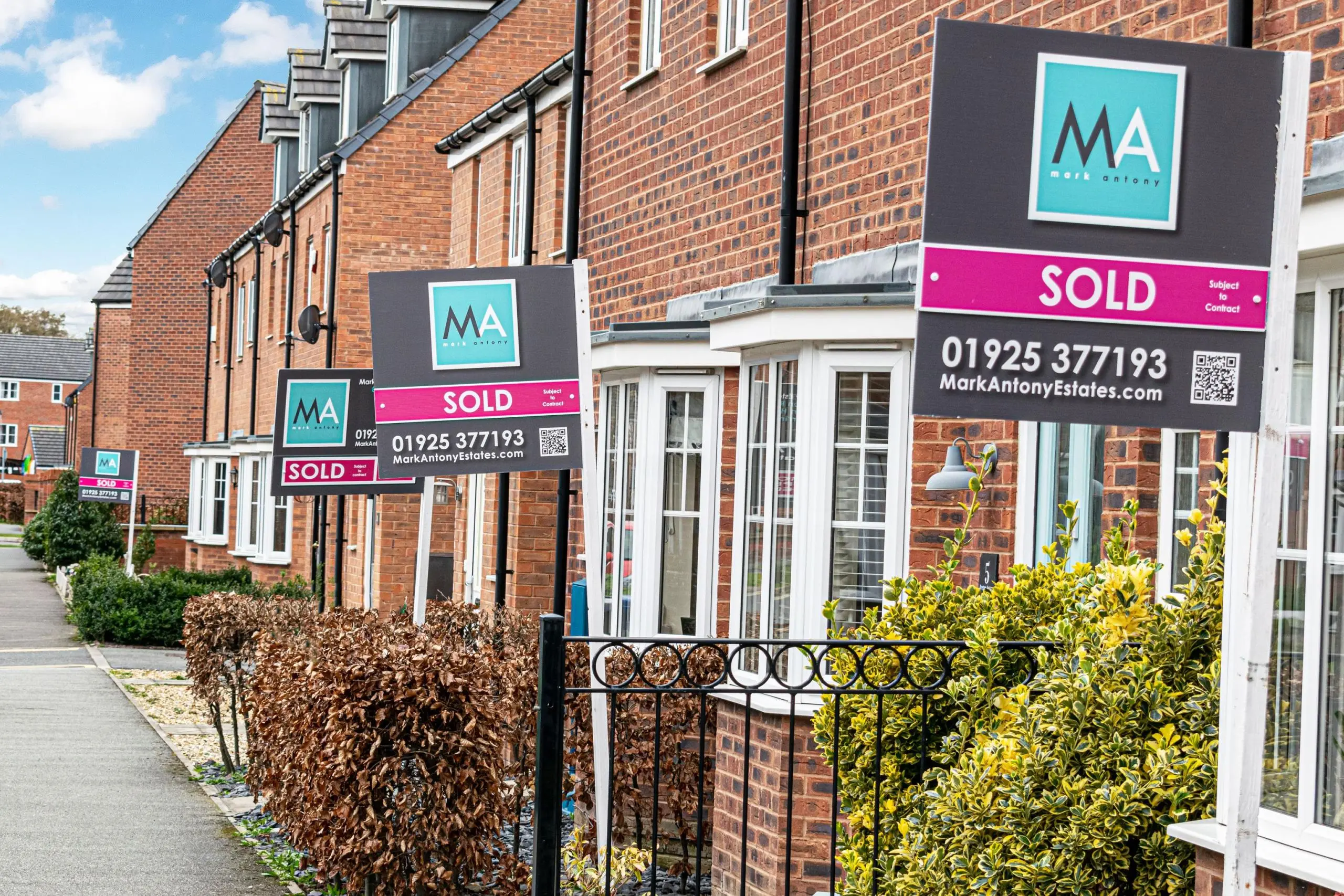 A street with multiple Sold boards sold by mark antony estates