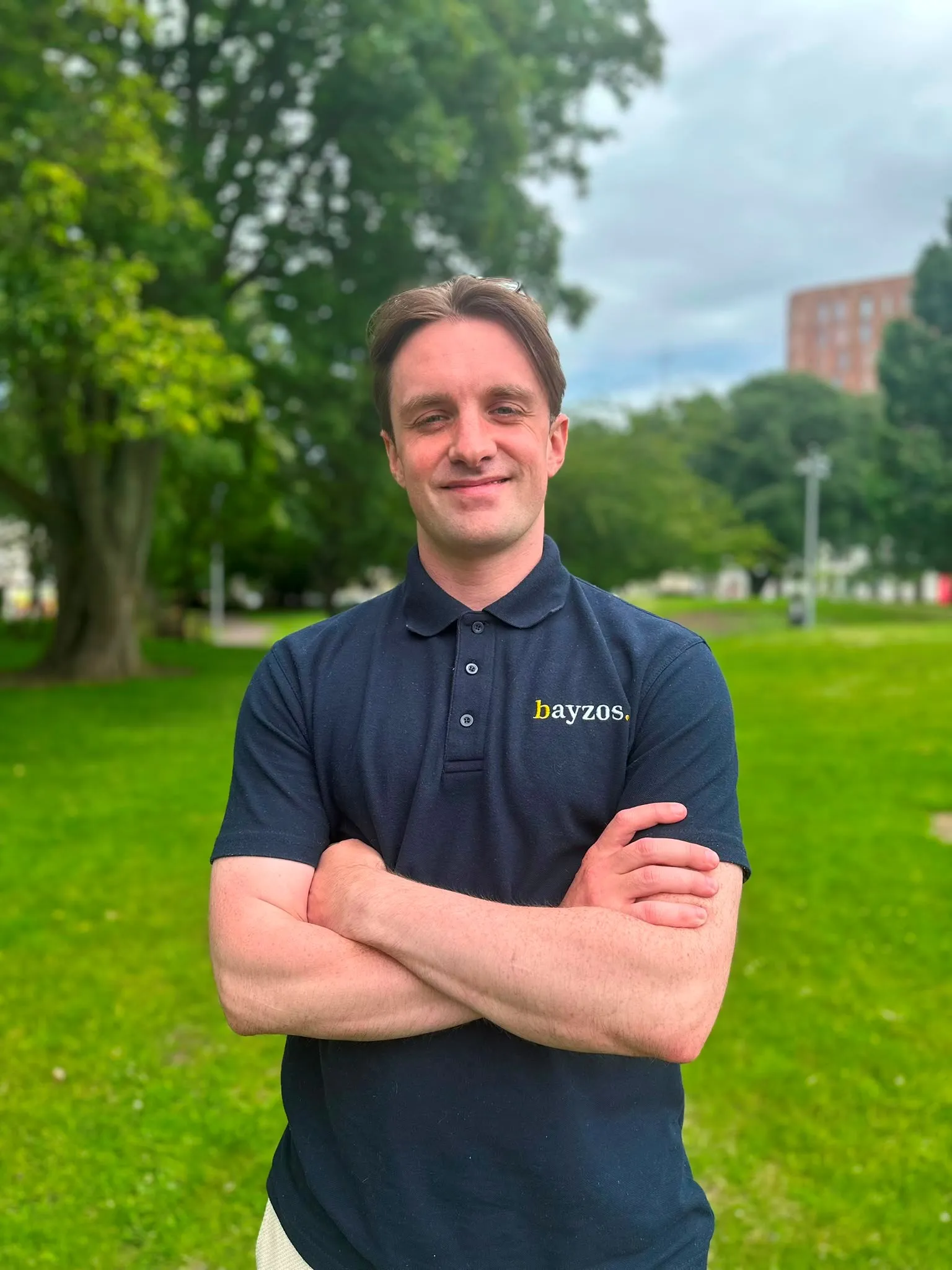 Connor, a certified negotiator for bayzos estate agents stands in a park in Coventry