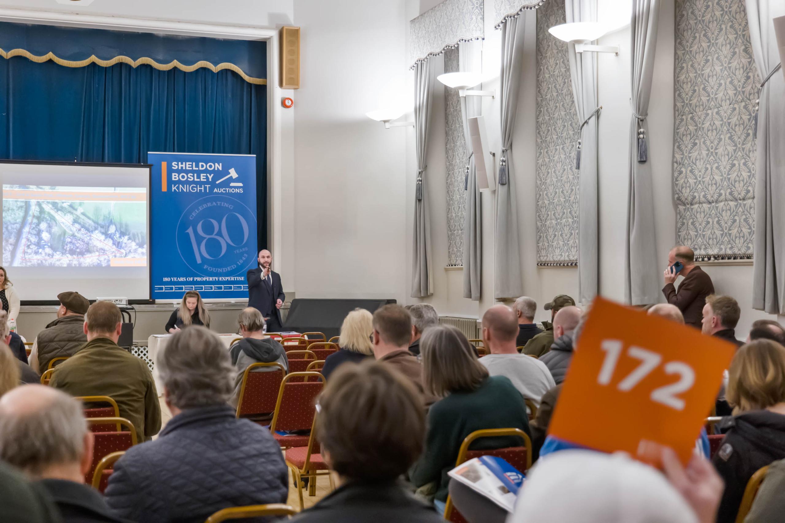 A property auction with a crowd of people