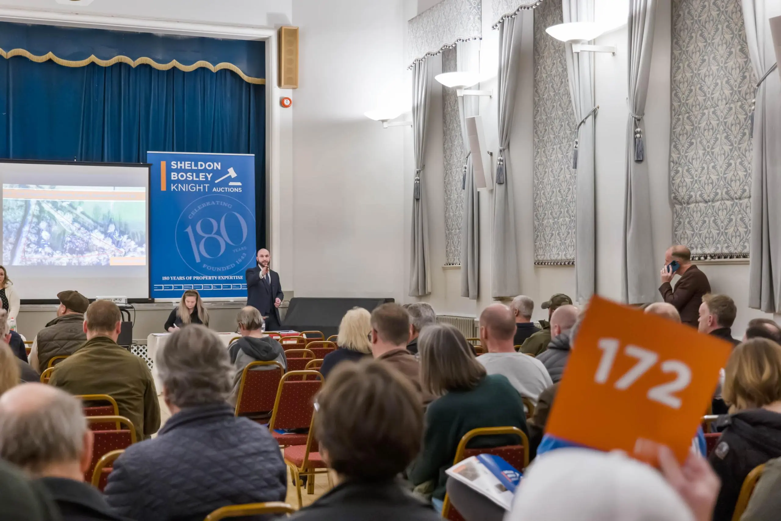 A property auction with a crowd of people