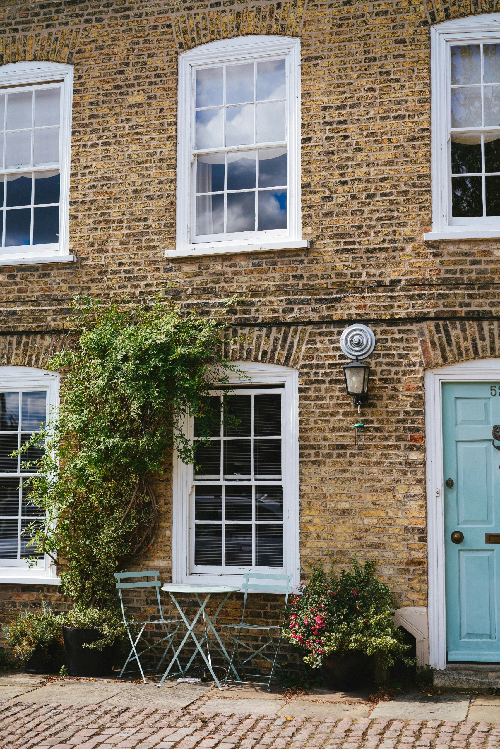 Traditional brick house exterior with professional consultation