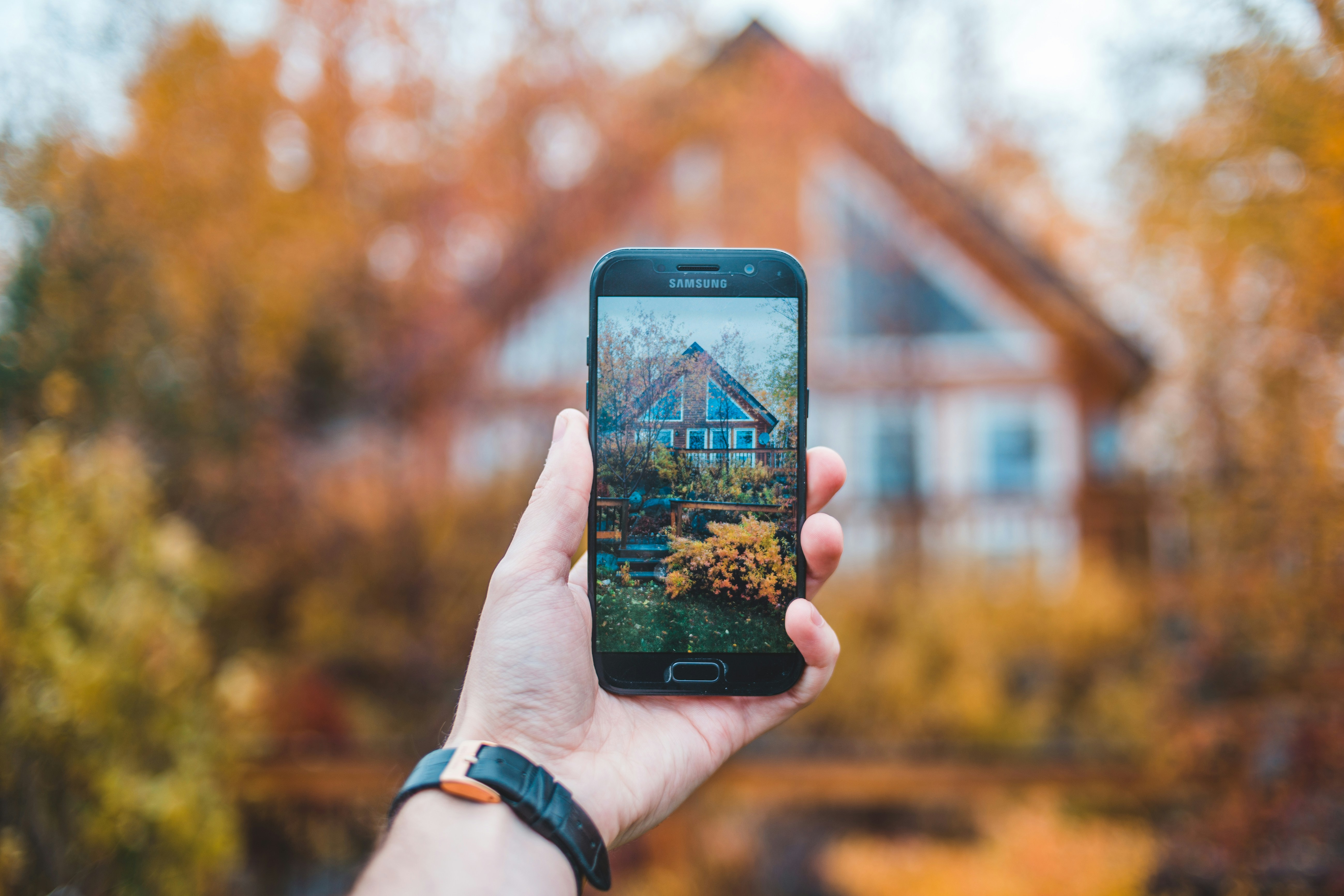 Person using smartphone to check property
