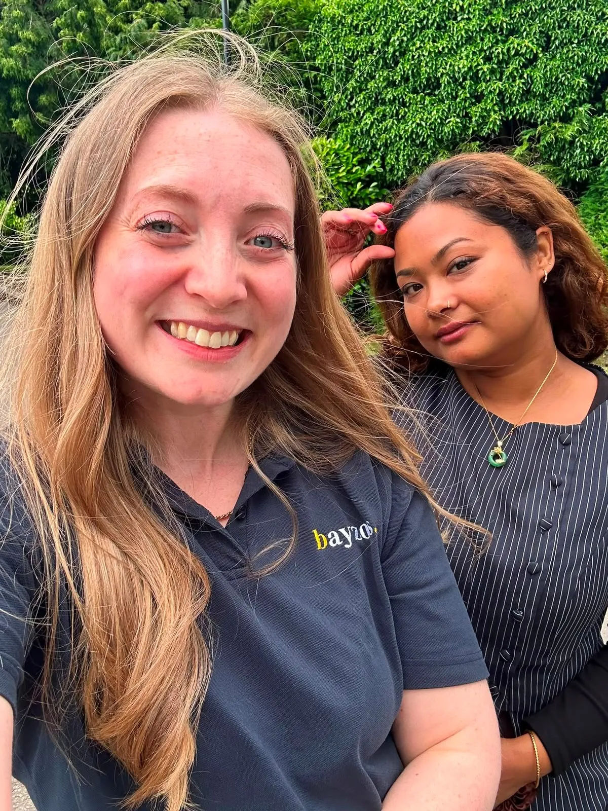 Christie stands with Benisha, a support team member at Bayzos estate agents