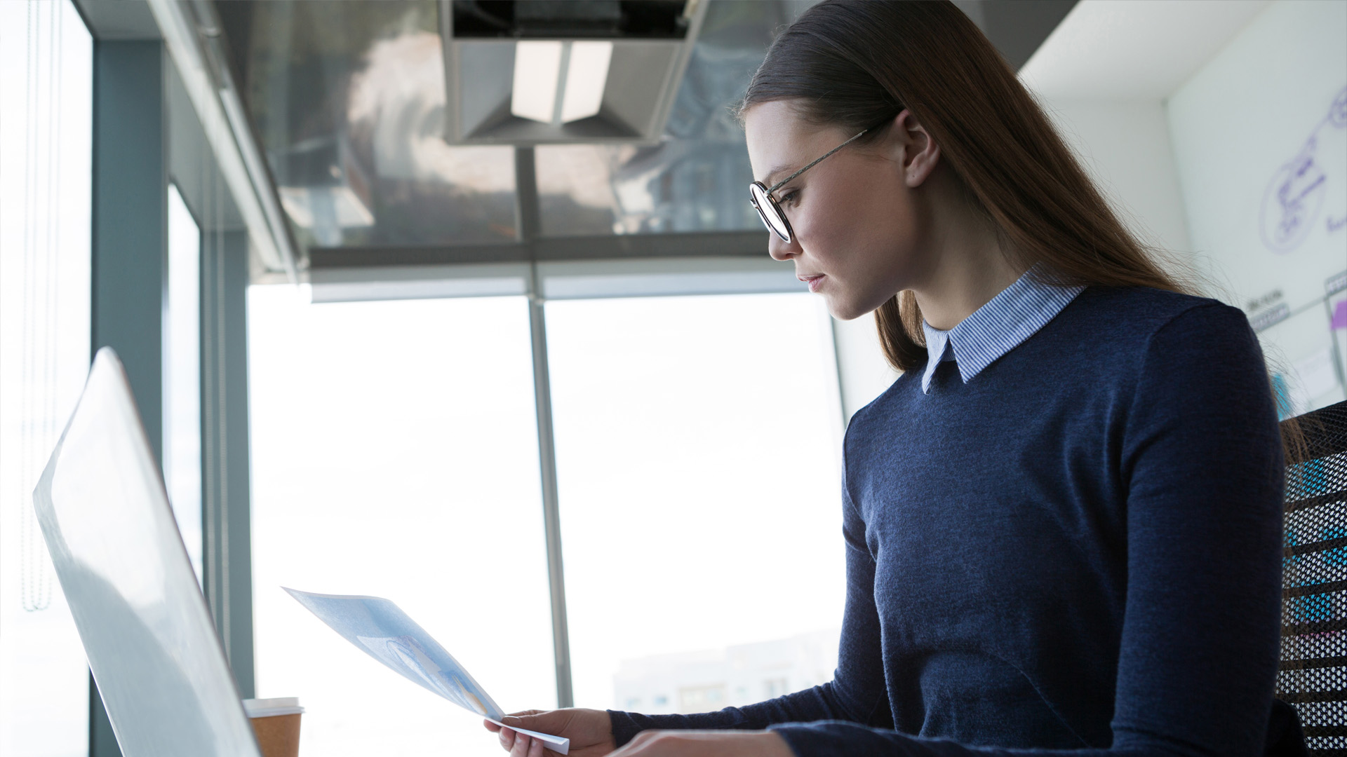 A lawyer sits in an office reviewing paperwork
