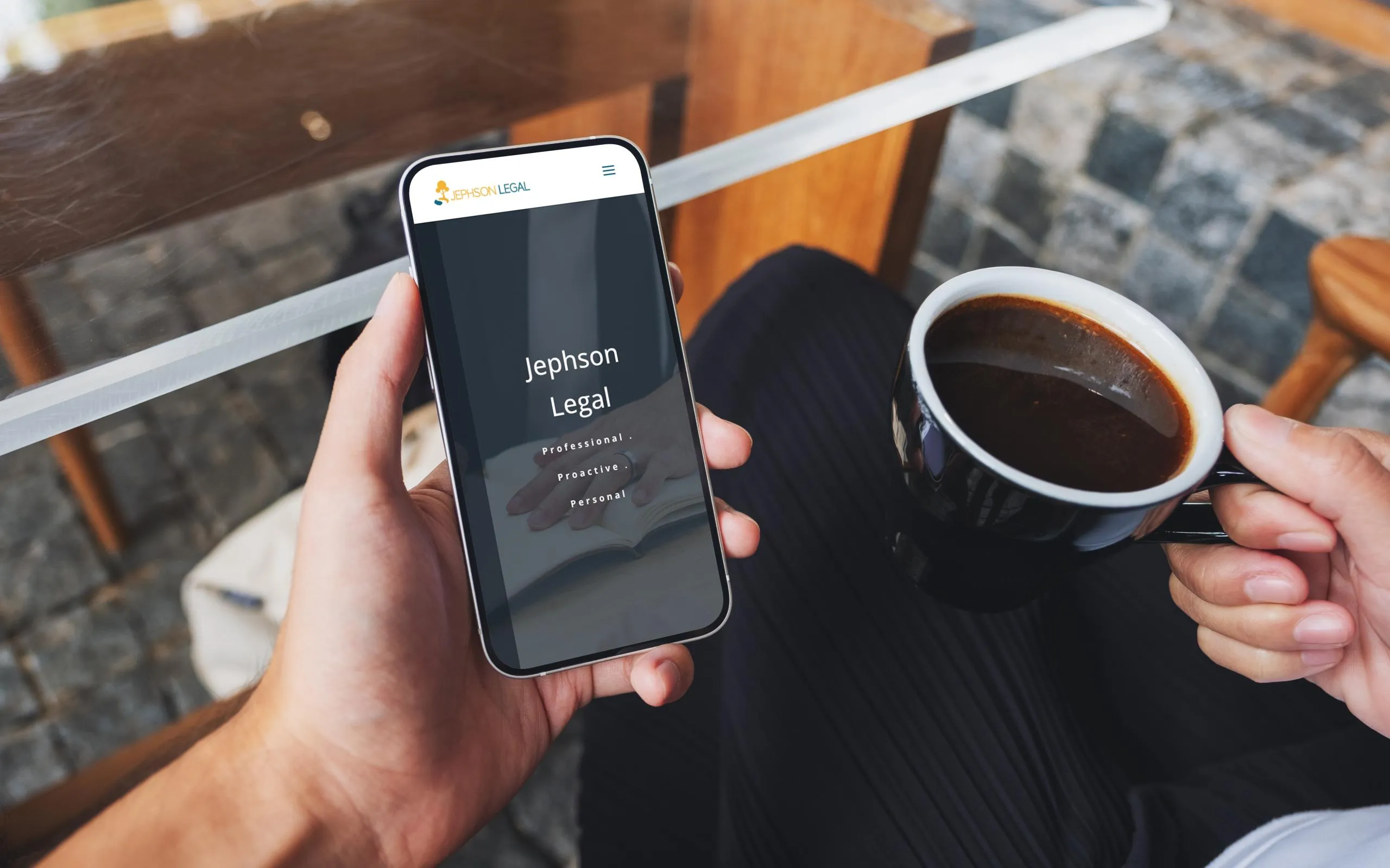 A homeowner sits with a cup of coffee, holding a phone showing the Jephson Legal logo
