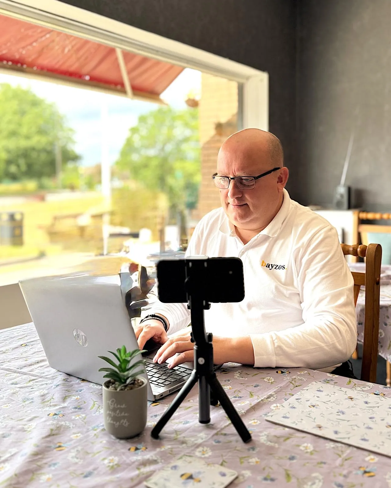 JC, an estate agent at bayzos, updating homeowners on  the performance of their property listing.
