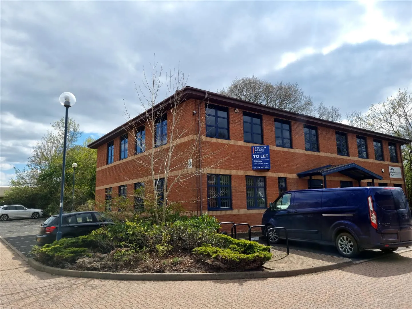 A commercial building with a Sheldon Bosley Knight "to let" sign outside