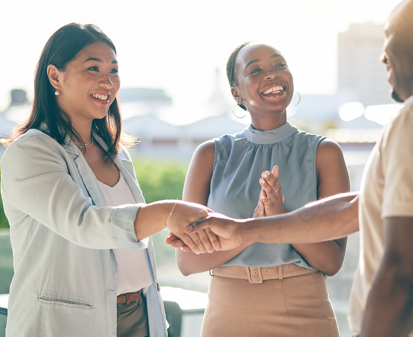 Buyers shaking hands with an estate agent