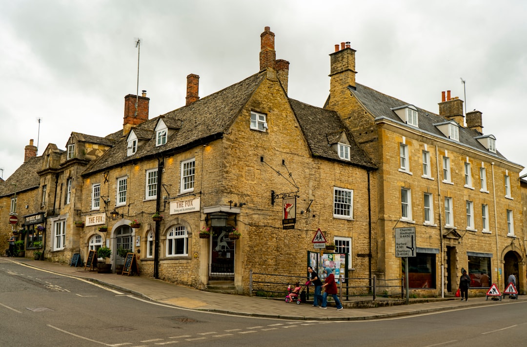 Traditional British high street with stone buildings representing Hunters' local community presence