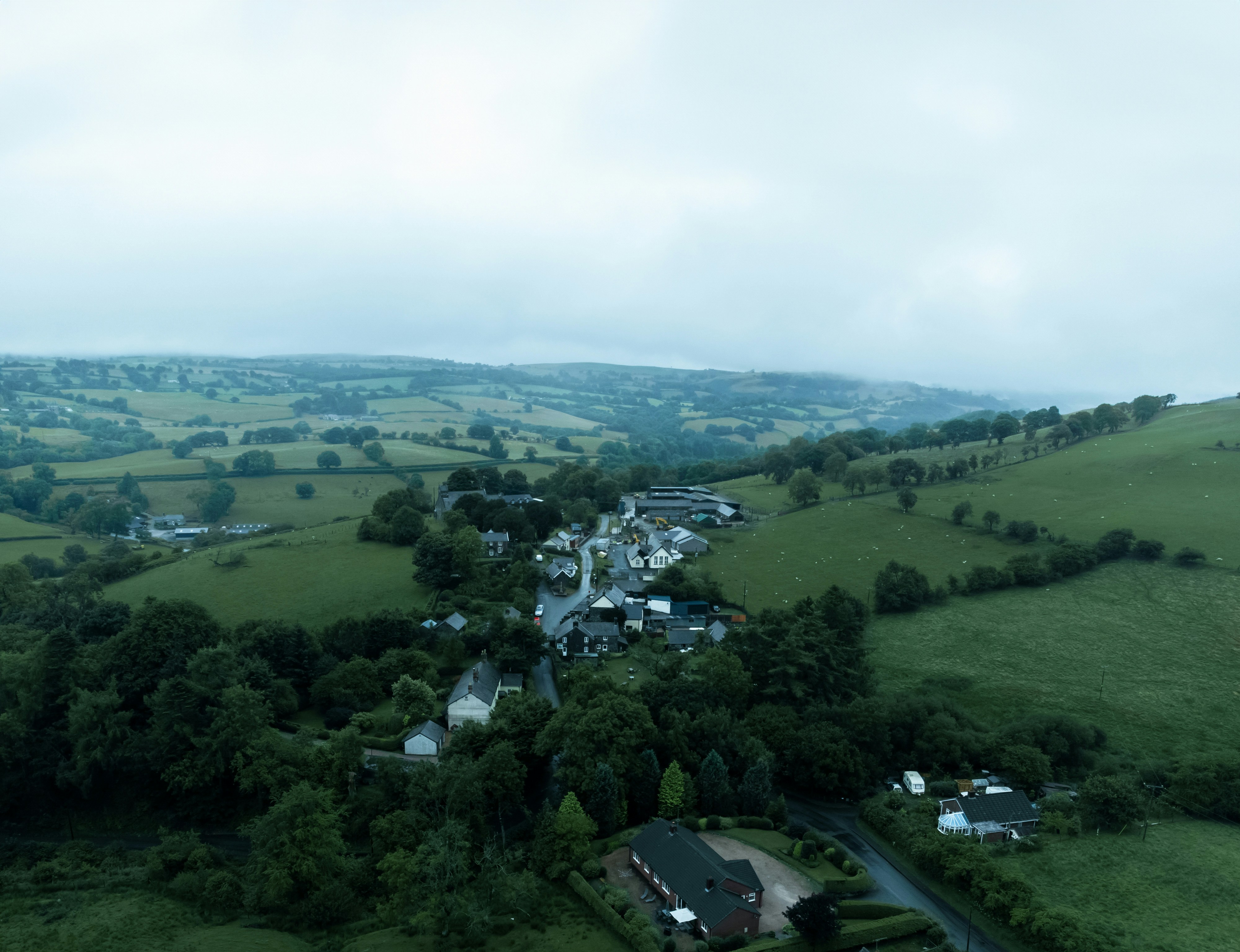 Aerial view of Welsh countryside with rolling green hills