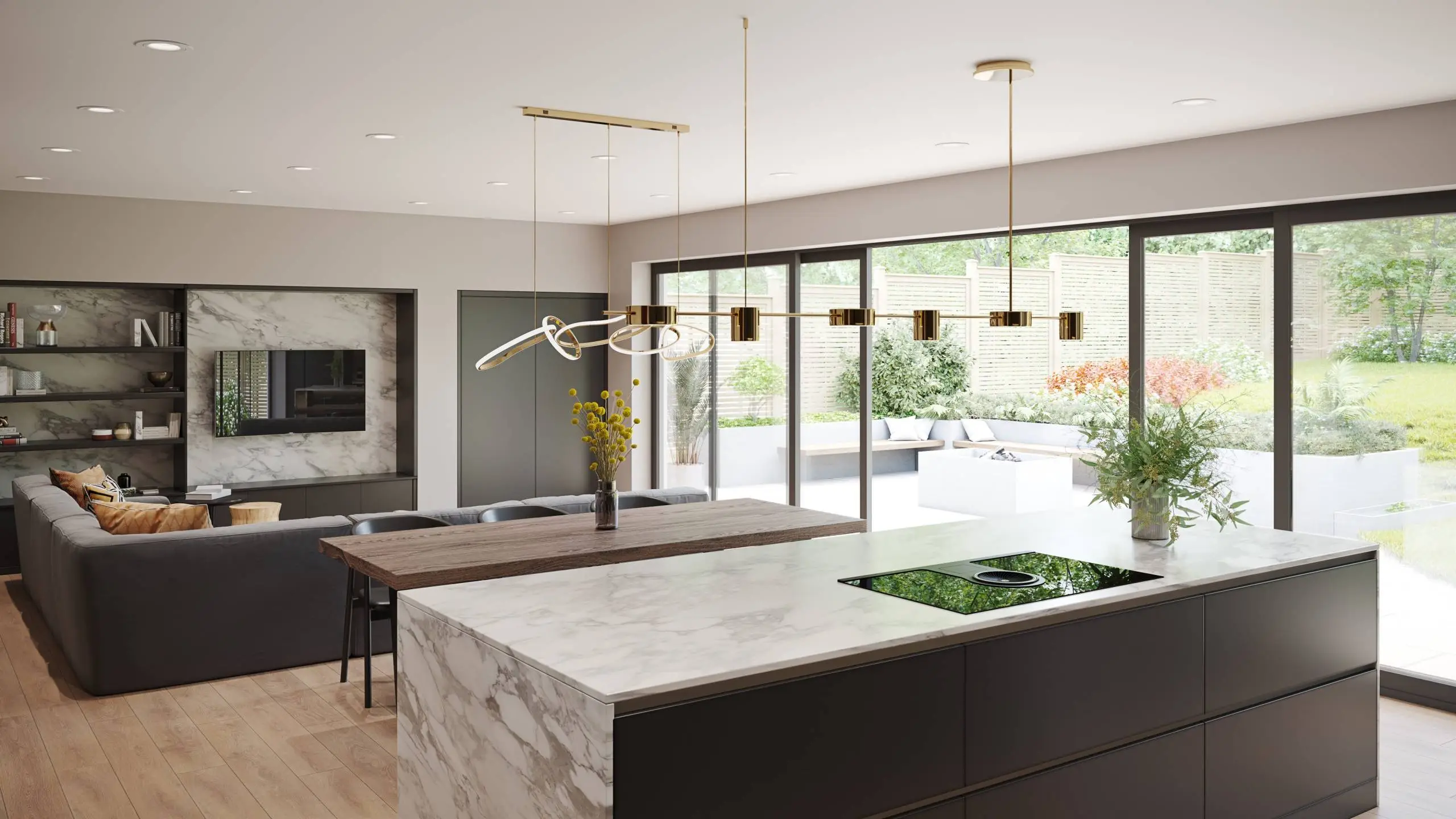 Open-plan kitchen and living room with marble island, dark cabinetry, pendant lights, and bi-fold doors opening to garden