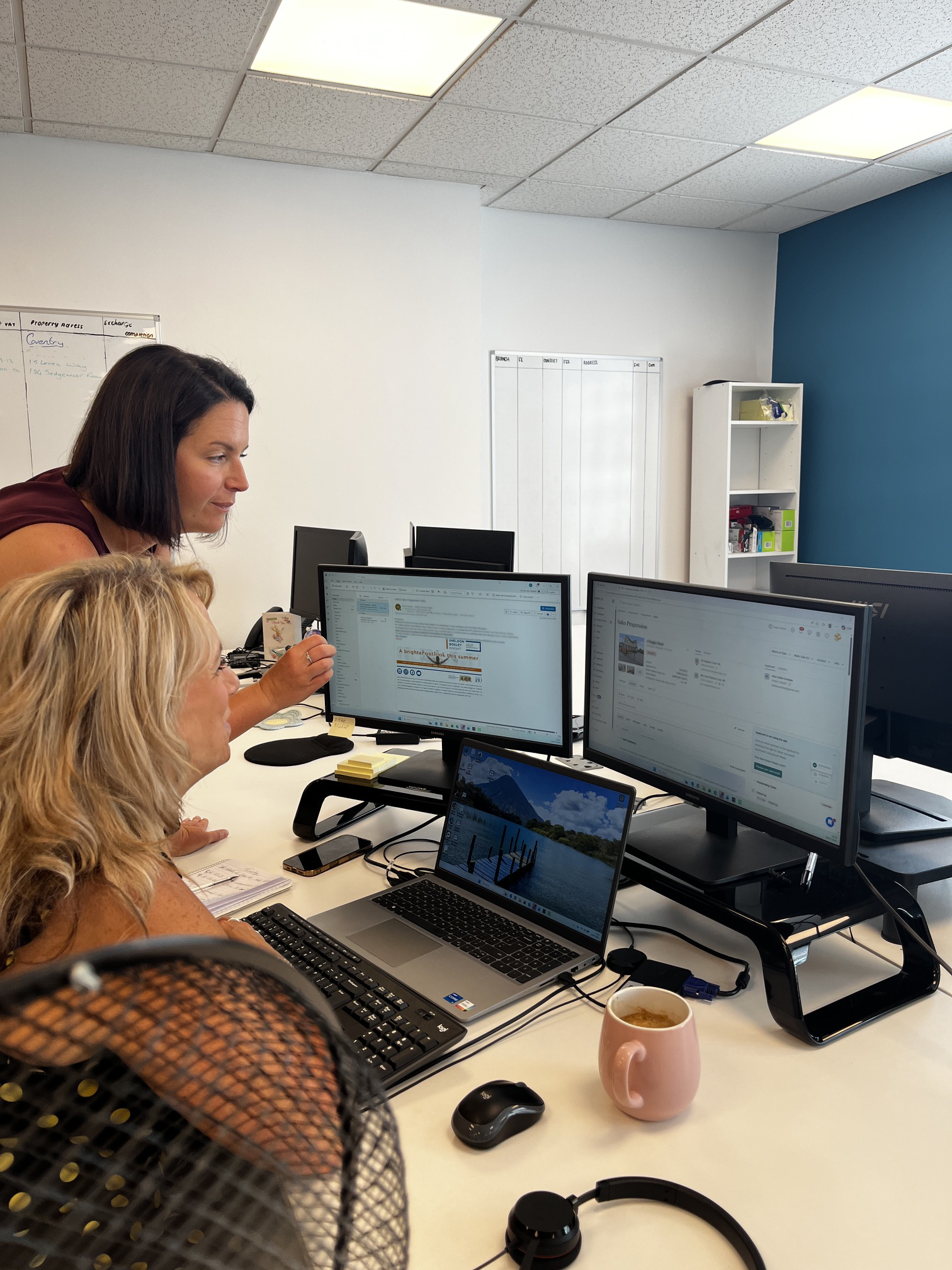 A legal representative talking over a desk to a client