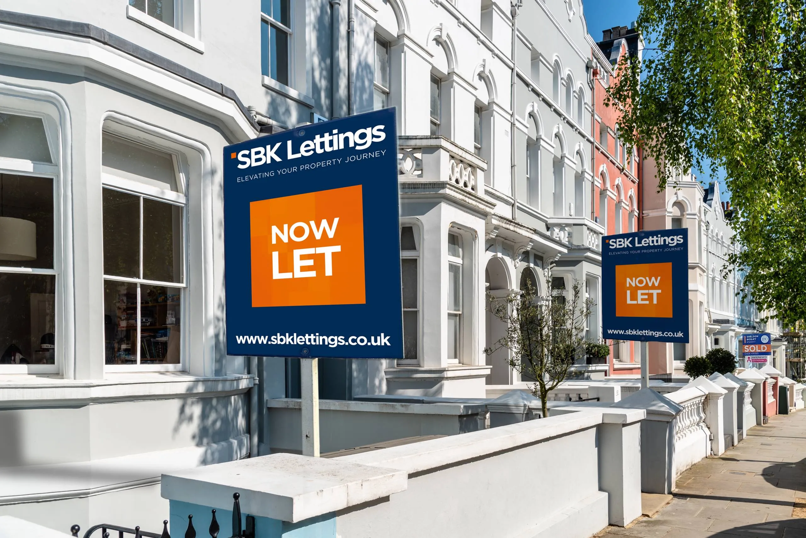 SBK Lettings signs showing Now Let outside a row of houses