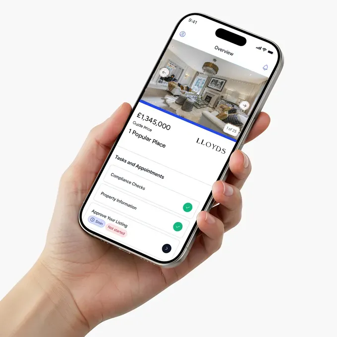 A hand holding a phone displaying a property overview screen from the Street.co.uk app.