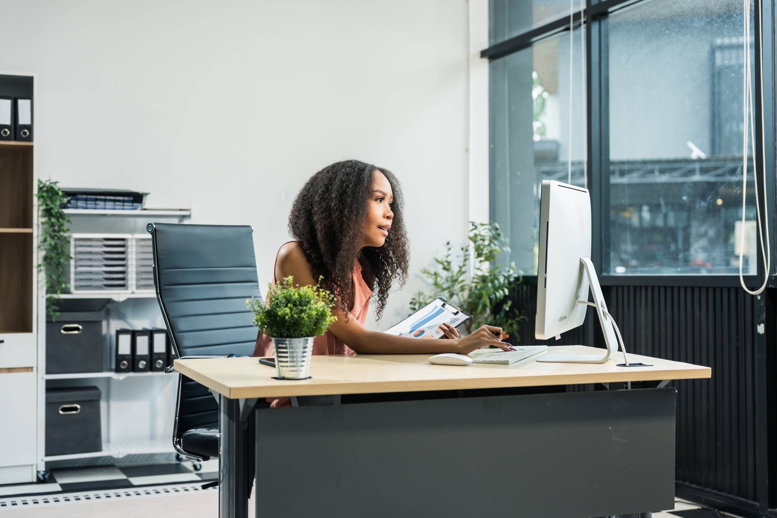 A sales progressor sits at their computer