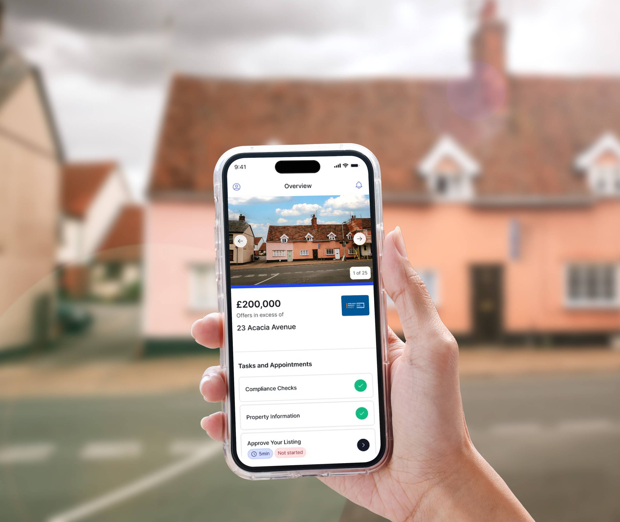 A hand holding a phone displaying a property overview screen from the Street.co.uk app.
