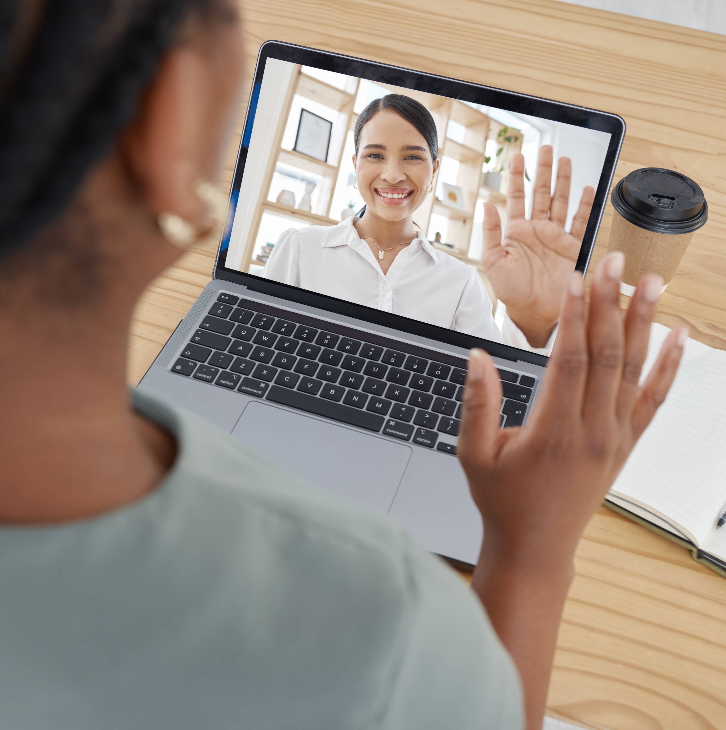 Two people on a zoom call waving at each other