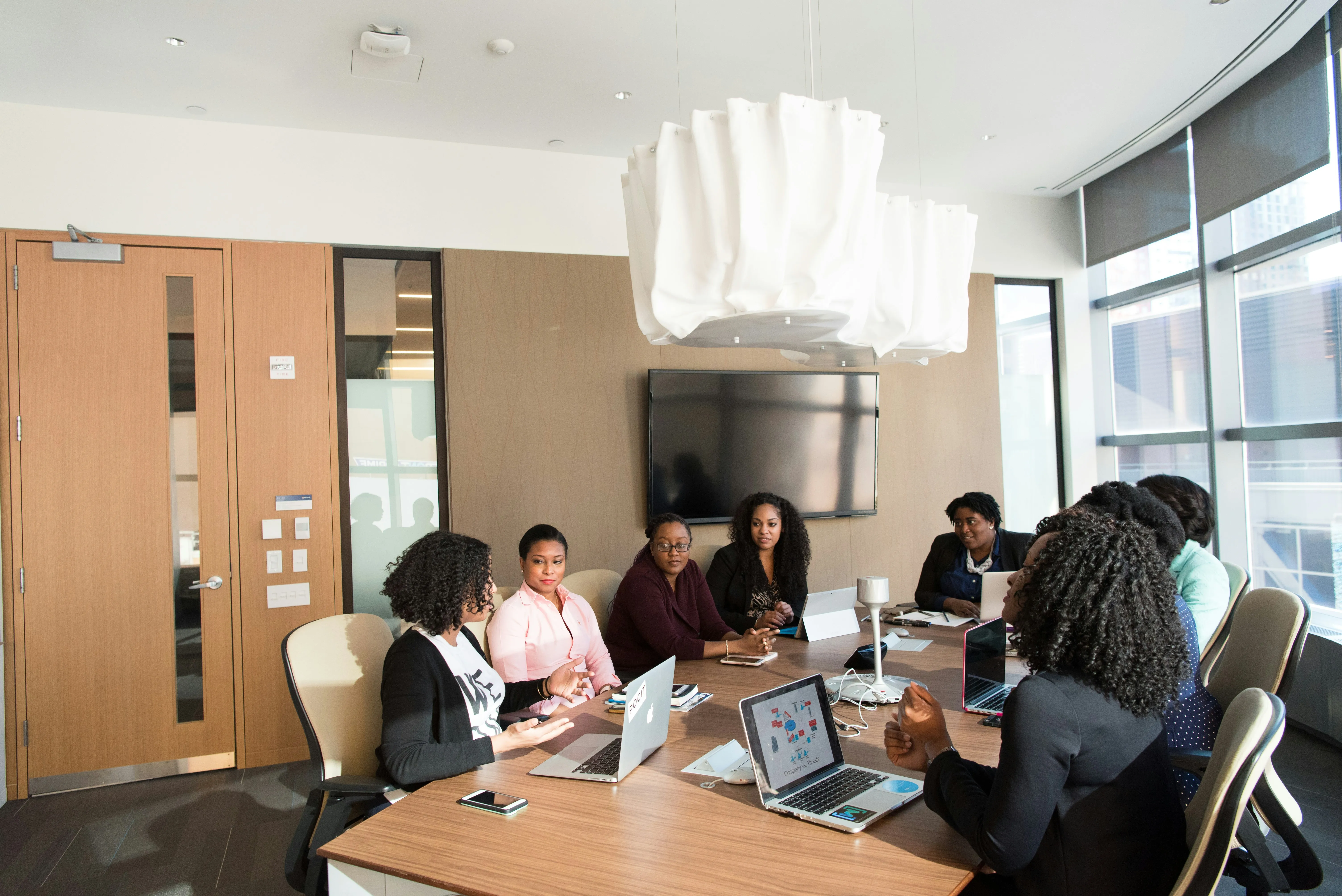 Team of professionals in a meeting room discussing a commercial property deal