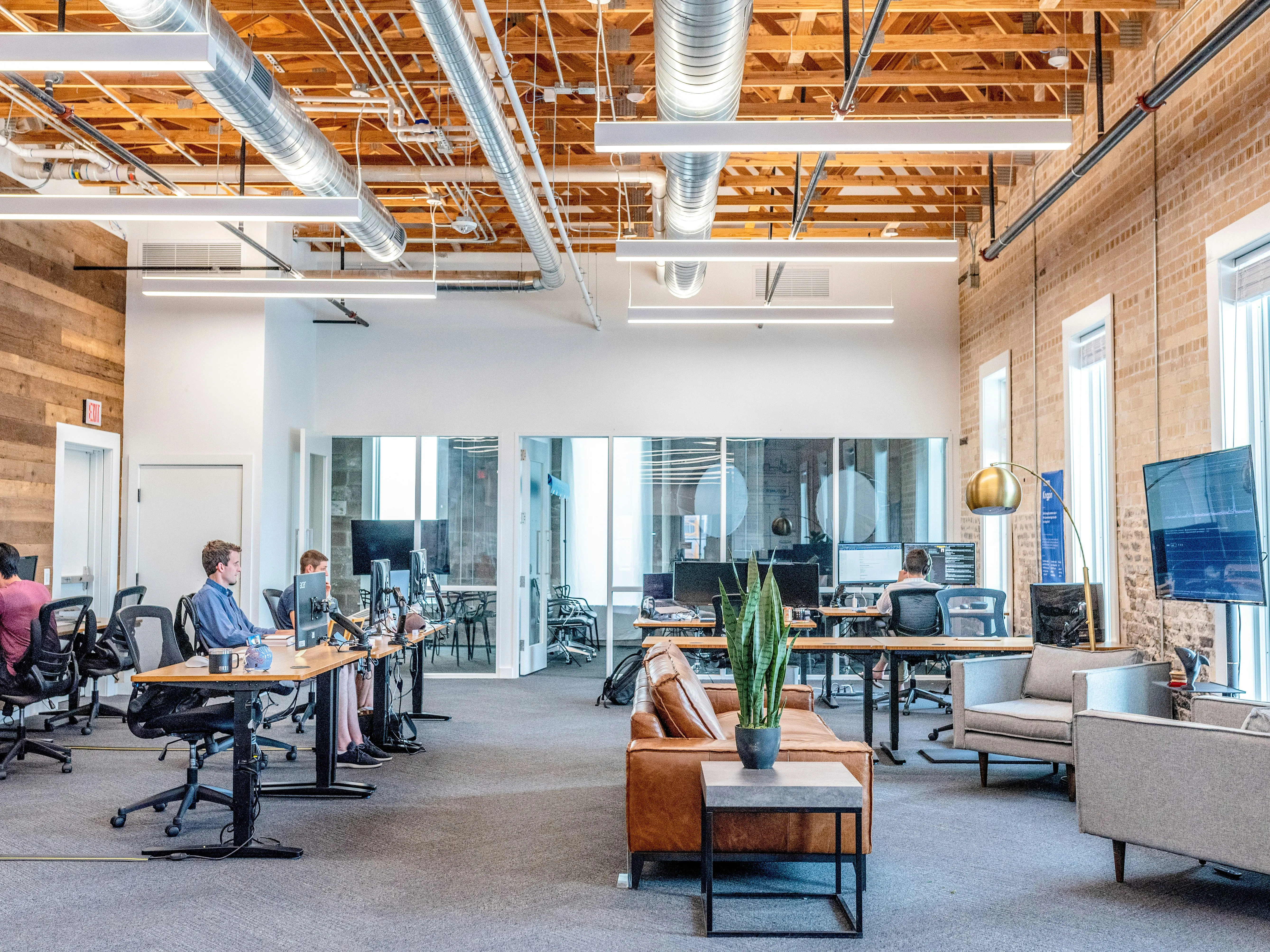 Commercial property team working together at office workstations