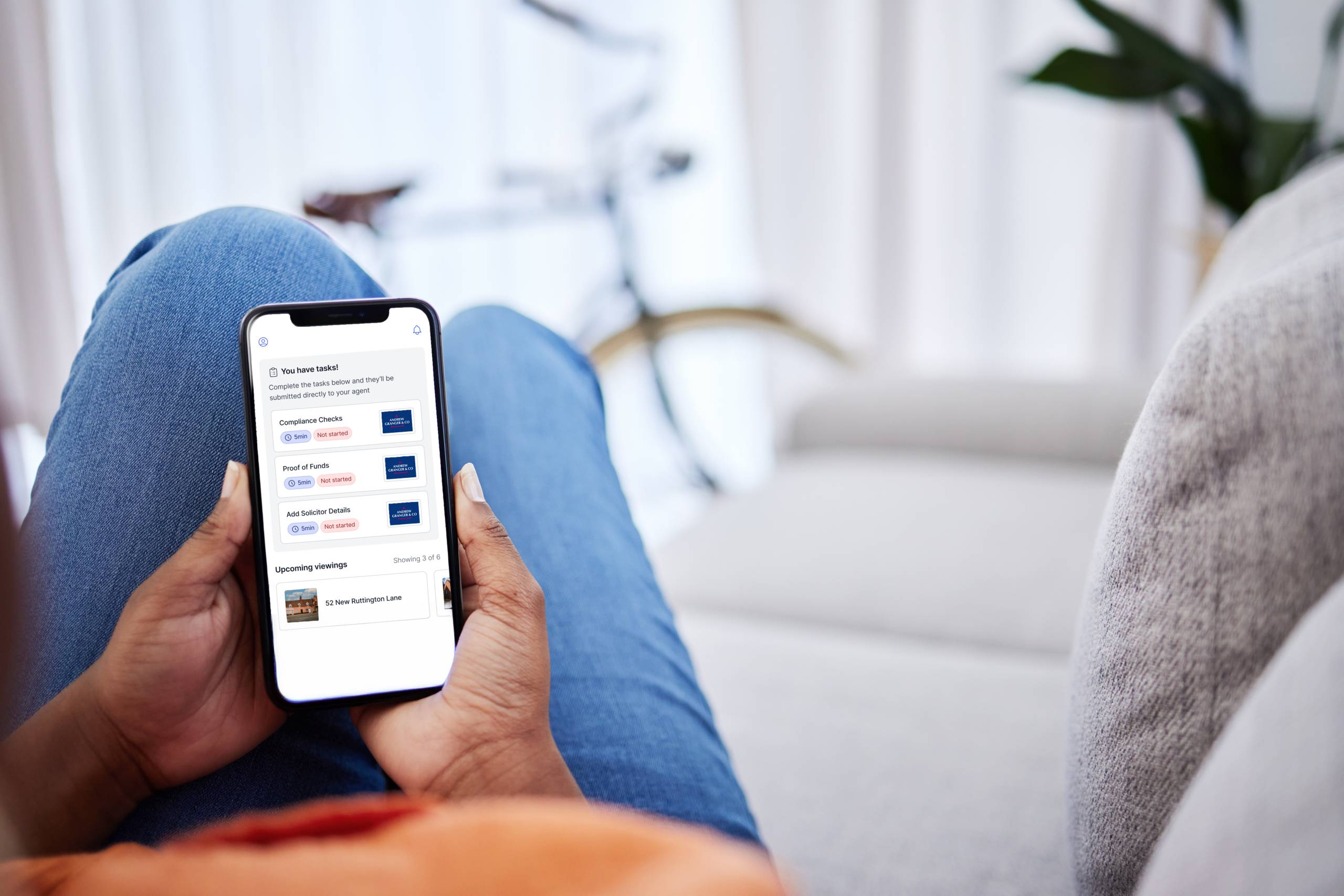 A smartphone in someone's hand displaying a task list in the street buyer app