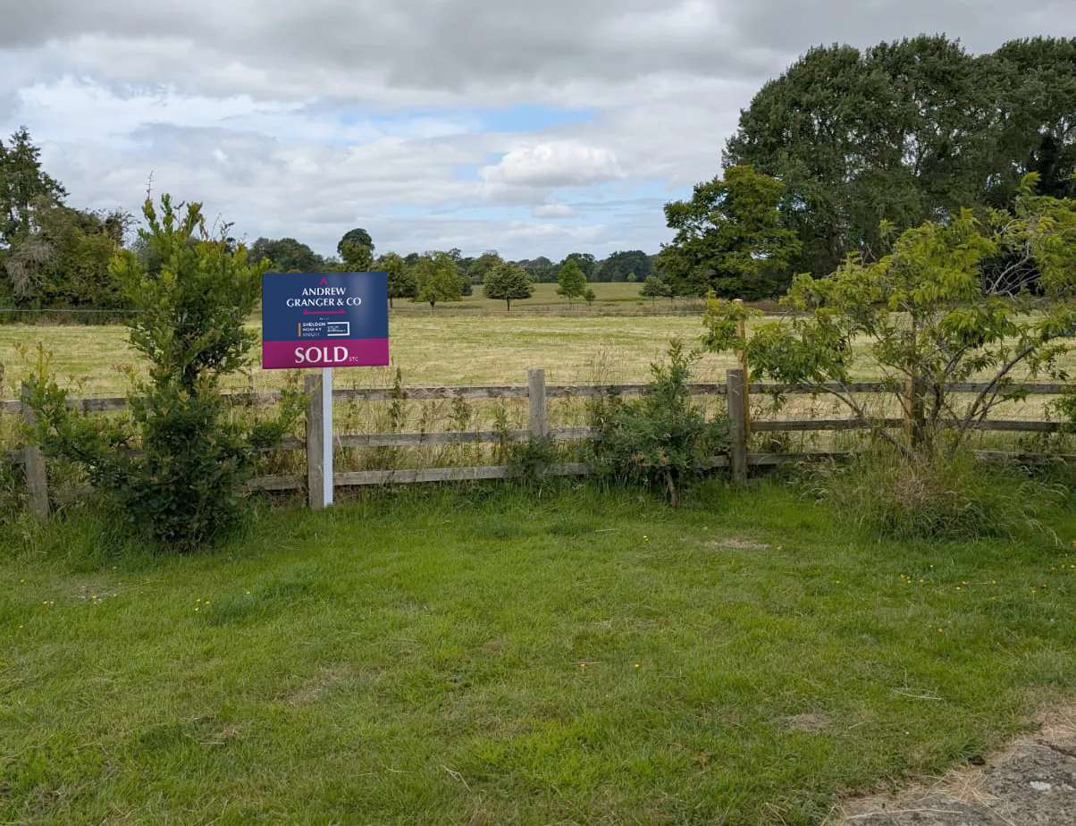 A field displaying an Andrew Granger sold board