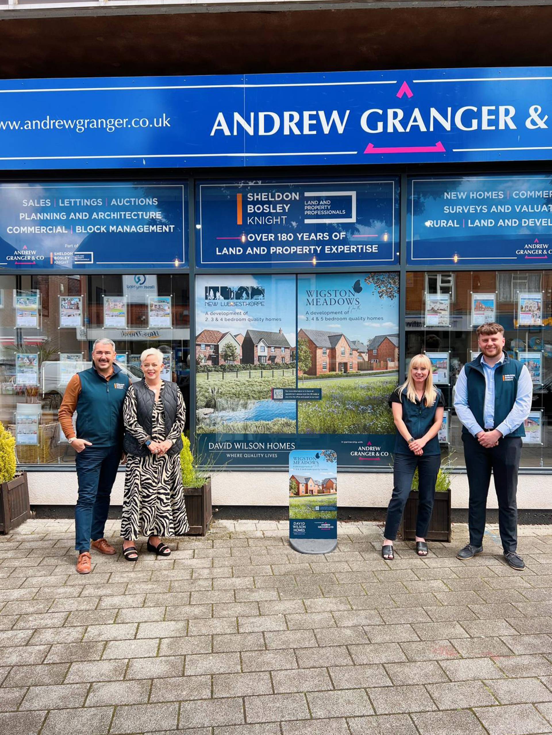 A group of estate agents from Andrew Granger & Co Leicestershire estate agents outside one of their branches