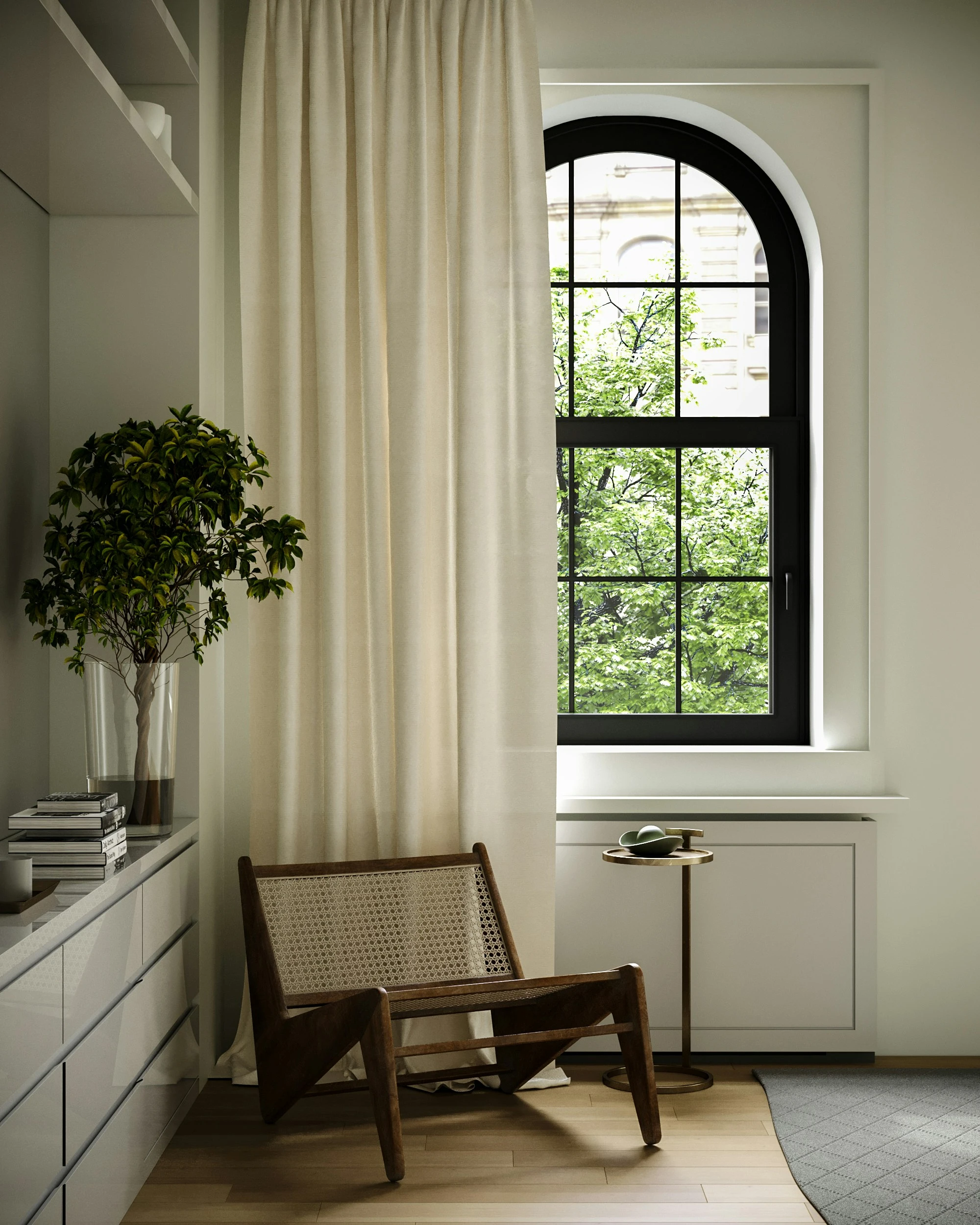 Modern interior seating nook with a woven cane lounge chair, floor-length cream drapes, and a black arched window looking out onto green foliage.