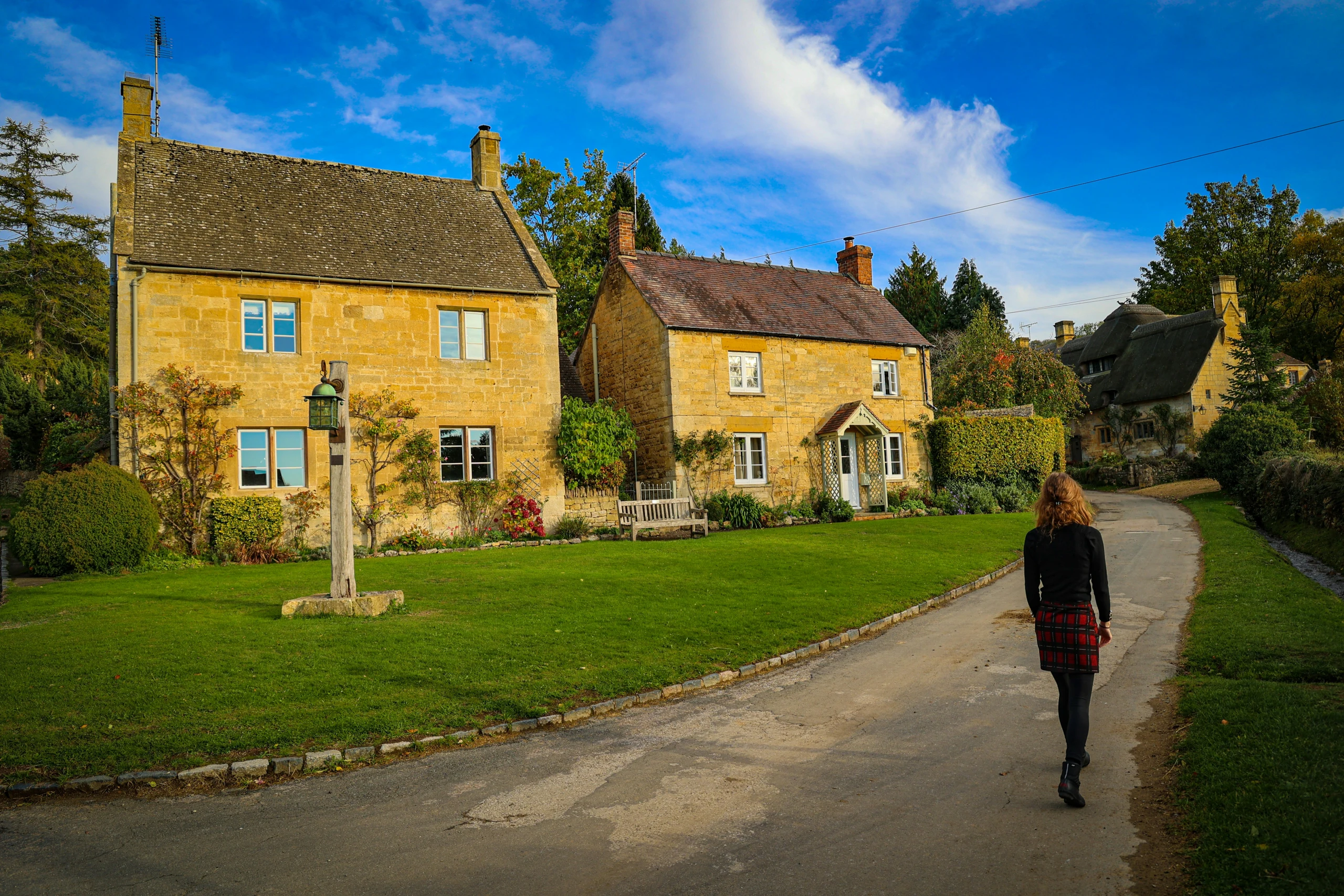 Woman walking towards a house, representing the start of the property selling journey