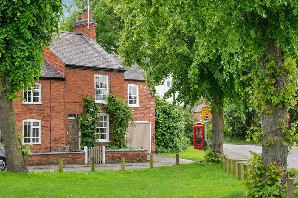 Red brick house with white windows situated in the South Leicestershire countryside