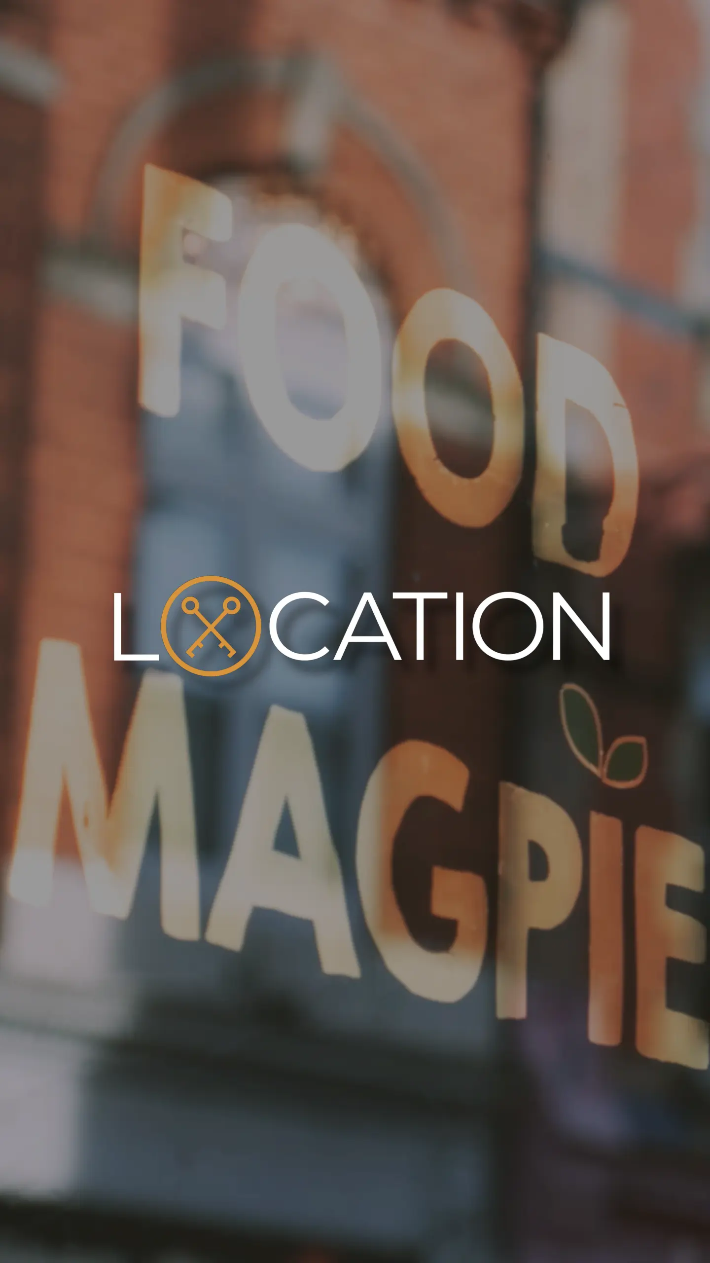 Window signage reading 'LOCATION' with a compass icon and partial text 'MAGPIE' visible on a brick building background