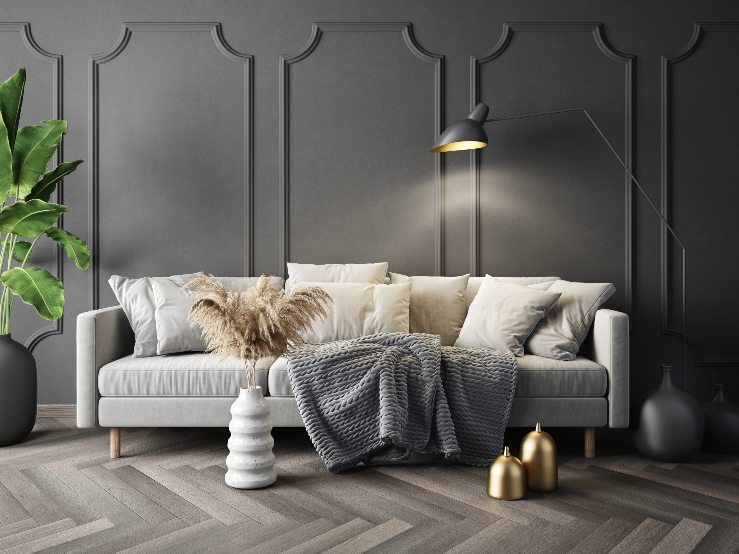 A cream sofa with cushions and throws