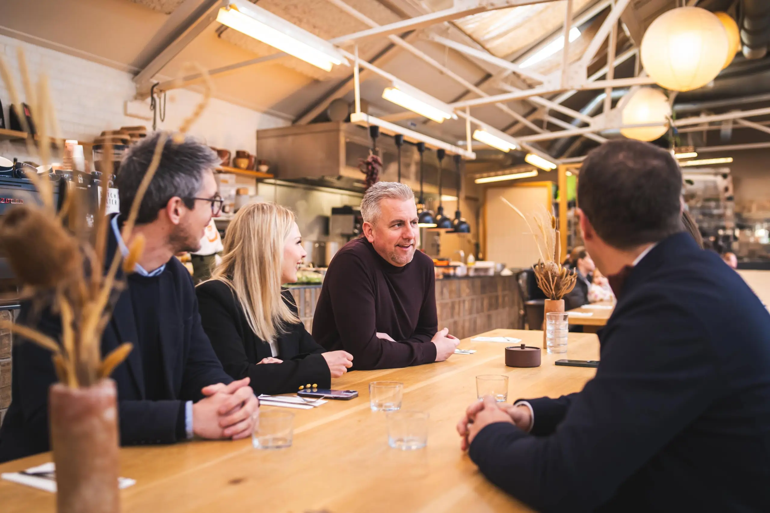 Redbrik Directors sat around a table in a cafe