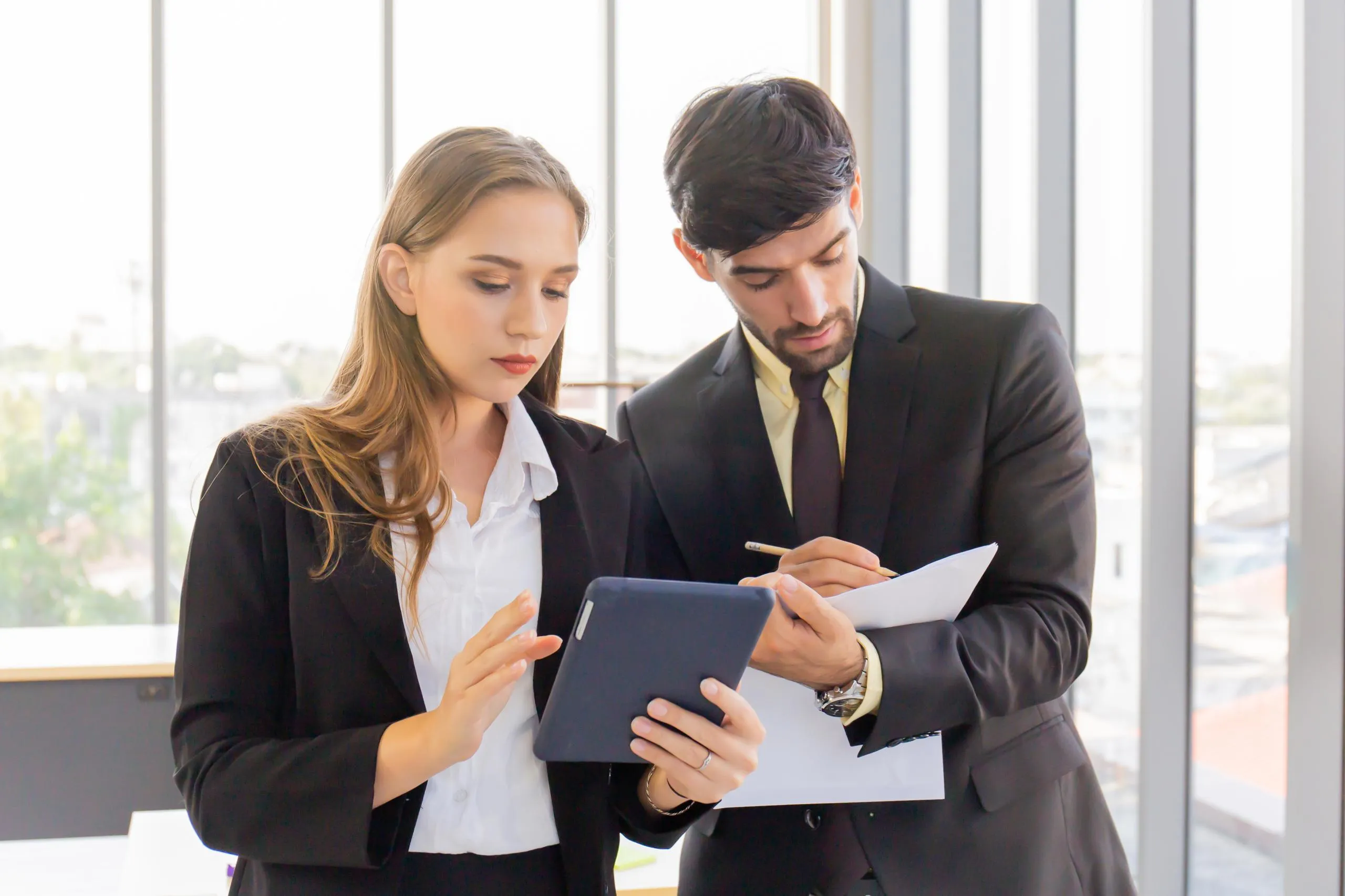 Two estate agents reviewing property details