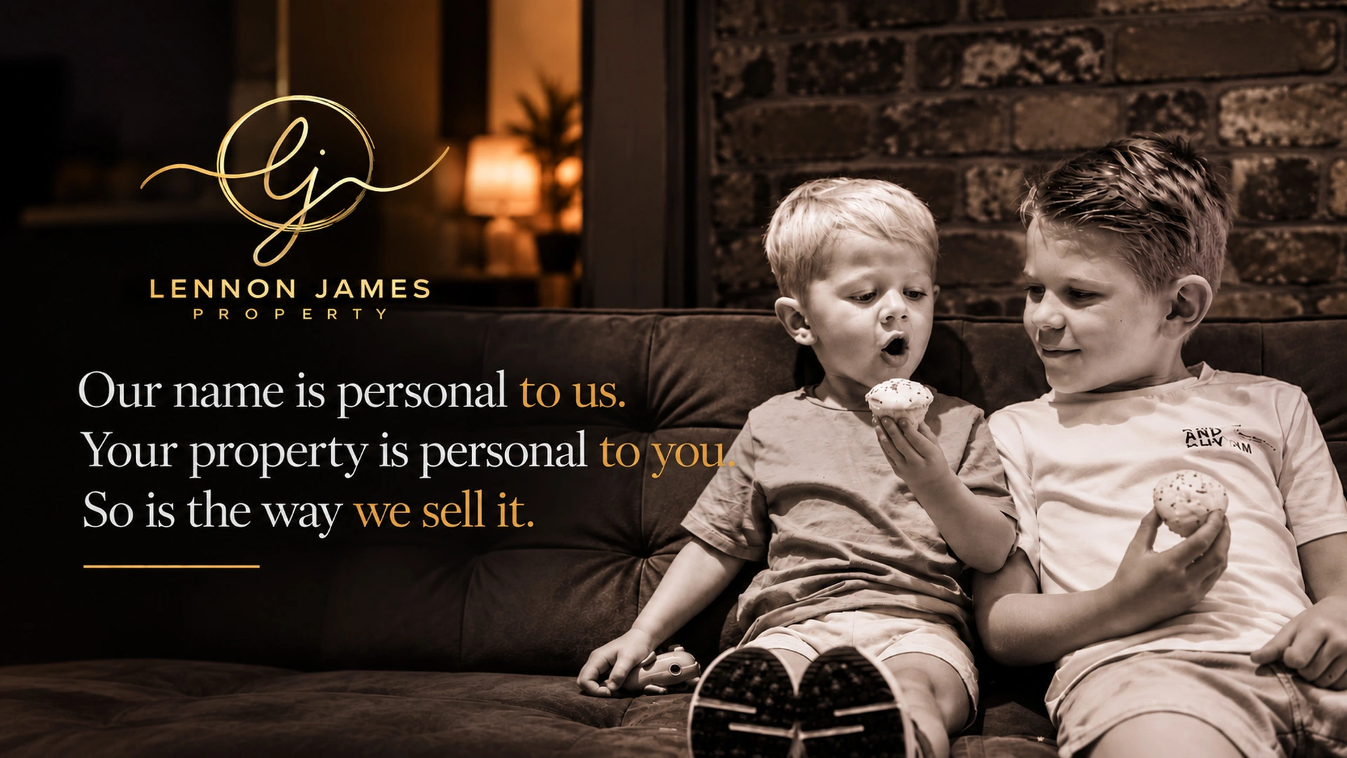 Two young children sitting on a dark sofa eating biscuits, with "Lennon James Property" branding and tagline visible
