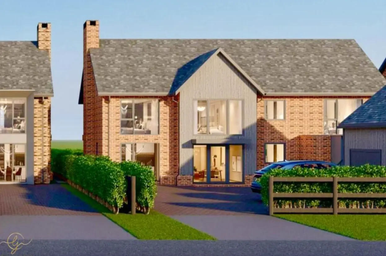 Architectural rendering of a row of three brick and rendered houses with pitched roofs, large windows, and hedged front gardens