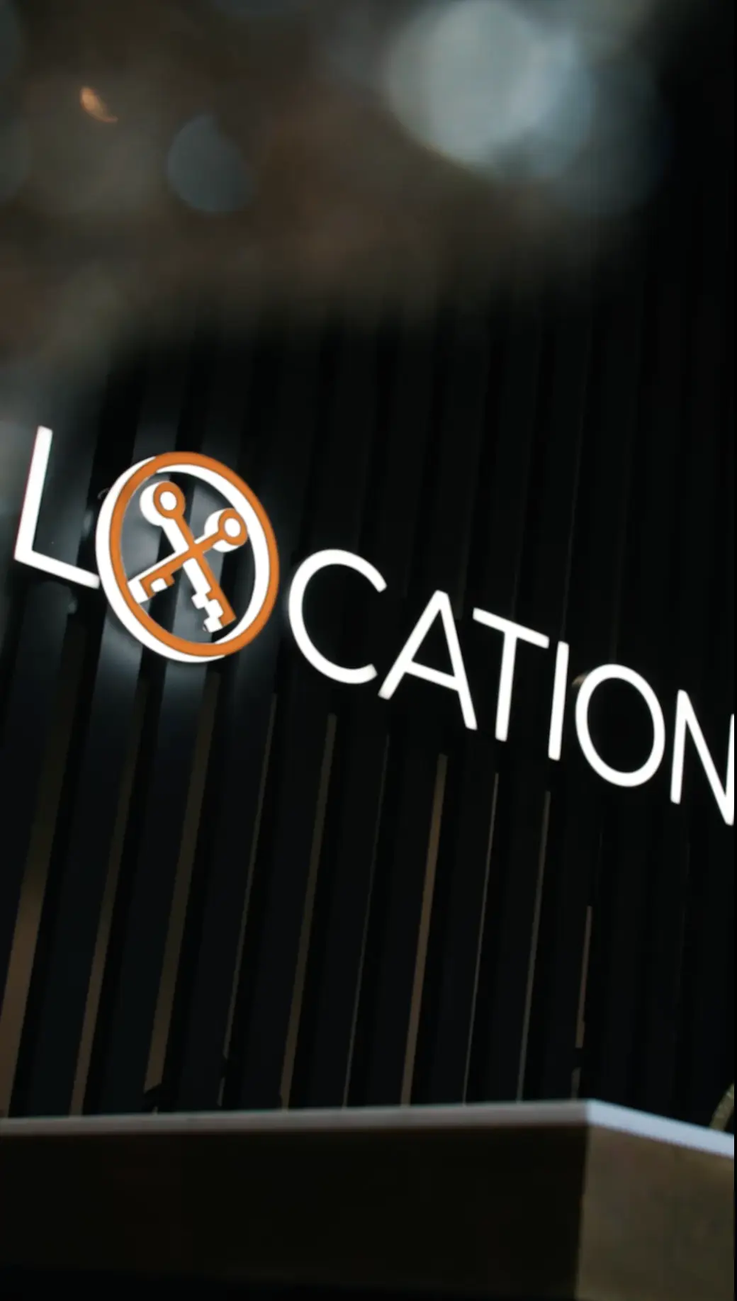 Location estate agency logo featuring an orange and grey circular wrench icon with white text reading 'LOCATION'