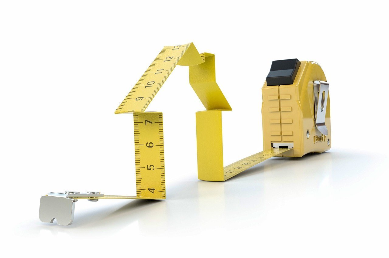 A tape measure making the shape of a house