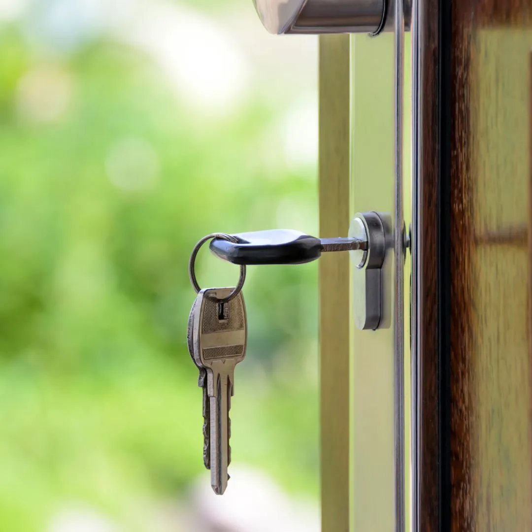 Key inserted into a door lock, symbolising secure access and property handover to new tenants