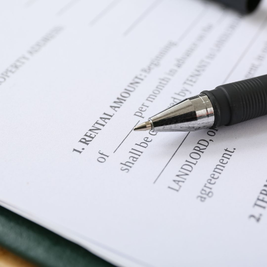 Close-up of a tenancy agreement showing rental amount details with a pen, representing rental terms and documentation