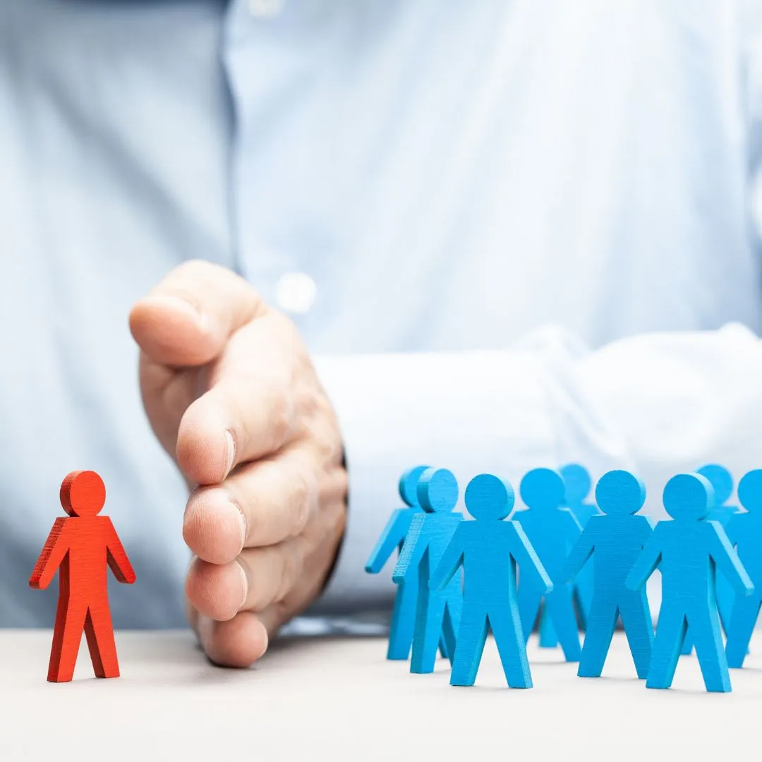 Hand separating one individual from a group, representing tenant selection, screening, or decision-making in property letting