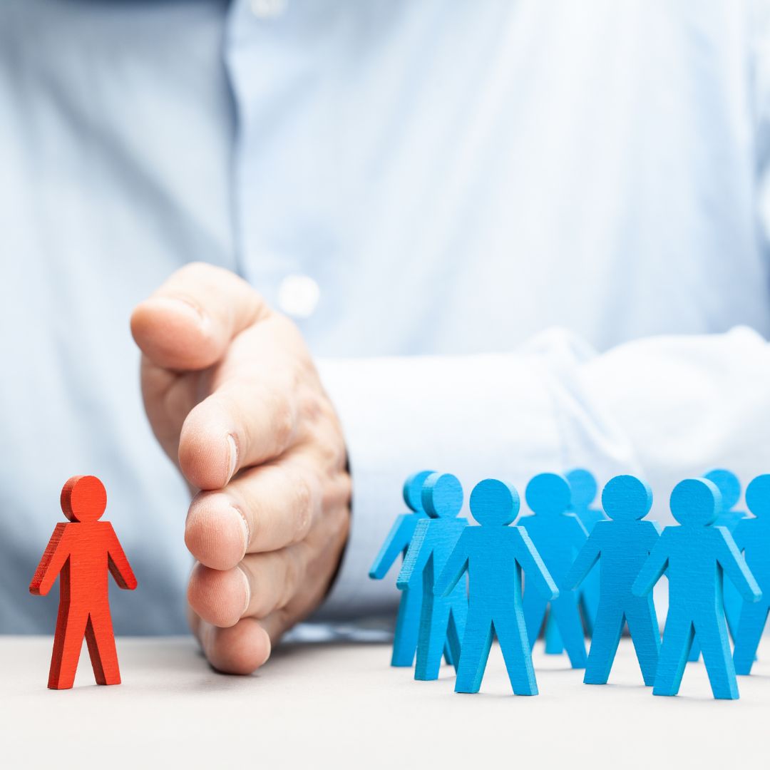 Hand separating one individual from a group, representing tenant selection, screening, or decision-making in property letting